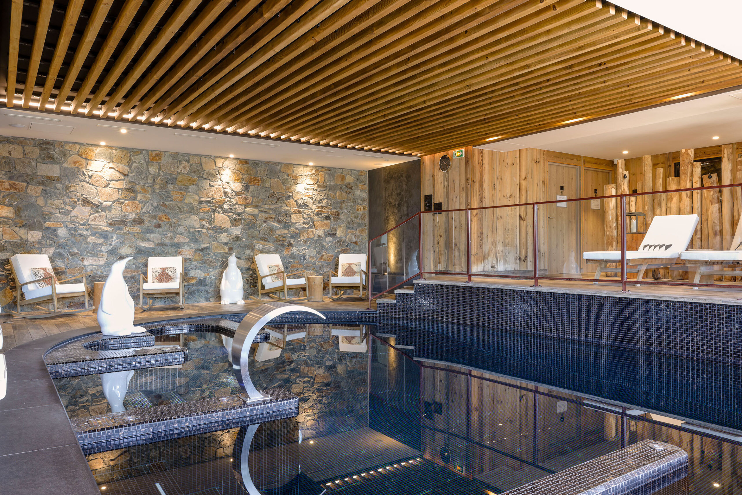 Không gian nội thất ấm cúng với gỗ và đá tại Hotel Spa Alpes d'Huez