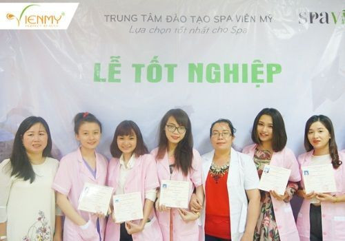 Một nhóm người mặc đồng phục chuyên nghiệp đang vui vẻ nhận chứng chỉ hoặc bằng cấp, thể hiện sự hoàn thành khóa đào tạo hoặc đạt được thành tích
