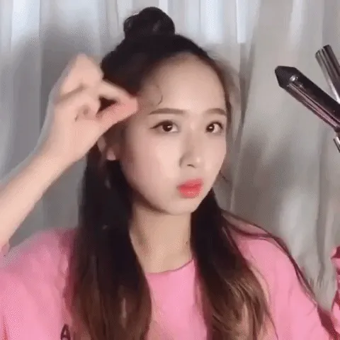 Kéo lỏng các lọn tóc trên đỉnh đầu để hoàn thiện kiểu búi củ tỏi cao