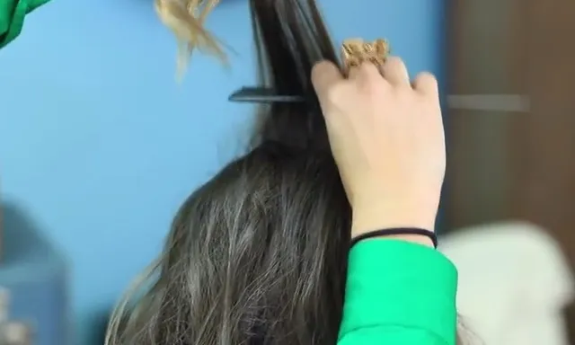 Hình ảnh người hướng dẫn đang chải lọn tóc từ trên xuống dưới