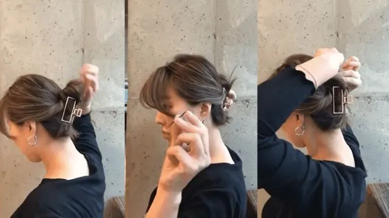 Một cô gái đang dùng kẹp càng cua để giữ nếp tóc uốn khi đi ra ngoài