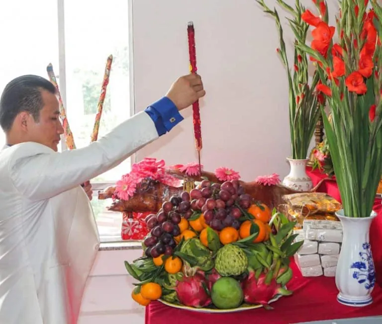 Hình ảnh người làm nghề tóc ăn mặc lịch sự, trang trọng khi thực hiện nghi thức cúng tổ nghề tóc