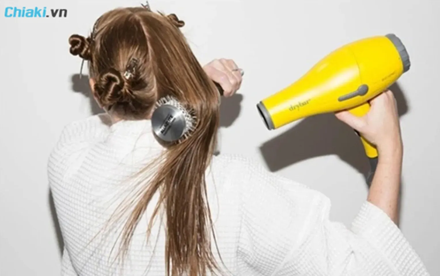 Sử dụng lược tròn để tạo kiểu cho tóc layer, cuốn nhẹ phần ngọn tóc vào bên trong hoặc ra ngoài tùy theo kiểu tóc mong muốn