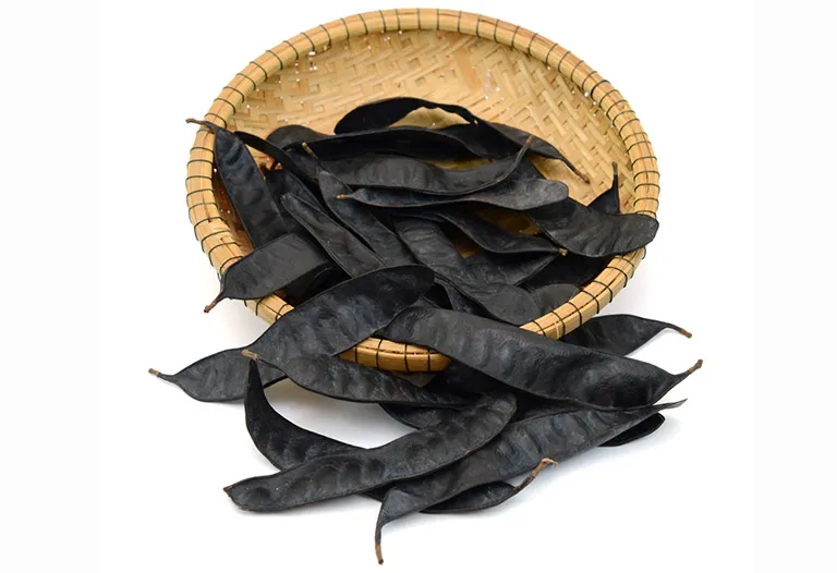 Hình ảnh quả bồ kết khô đang được nướng trên than hồng để chuẩn bị nấu nước gội đầu