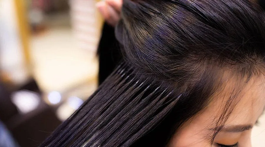 Người phụ nữ đang chải mái tóc nối dày dặn sau khi hoàn thành