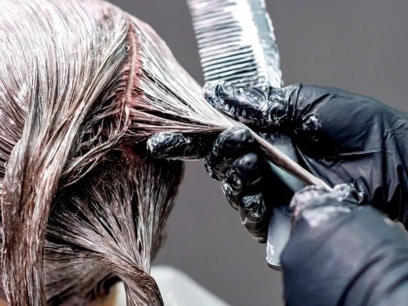 Hình ảnh minh họa một người đang kiểm tra nhiệt độ trong kho chứa mỹ phẩm chăm sóc tóc