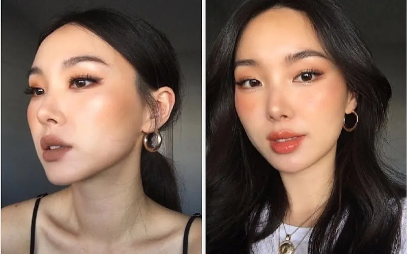 Một phụ nữ với kiểu trang điểm tông Tây sắc sảo, nhấn mạnh vào mắt và khối, đi kèm với kiểu tóc búi đánh rối cao hoặc thấp