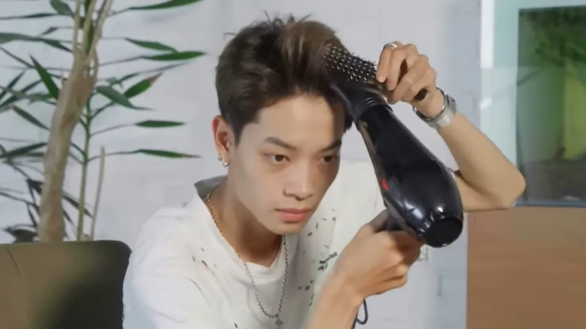 Kéo mái tóc Side Part phồng lên bằng lược tròn để tạo độ bồng