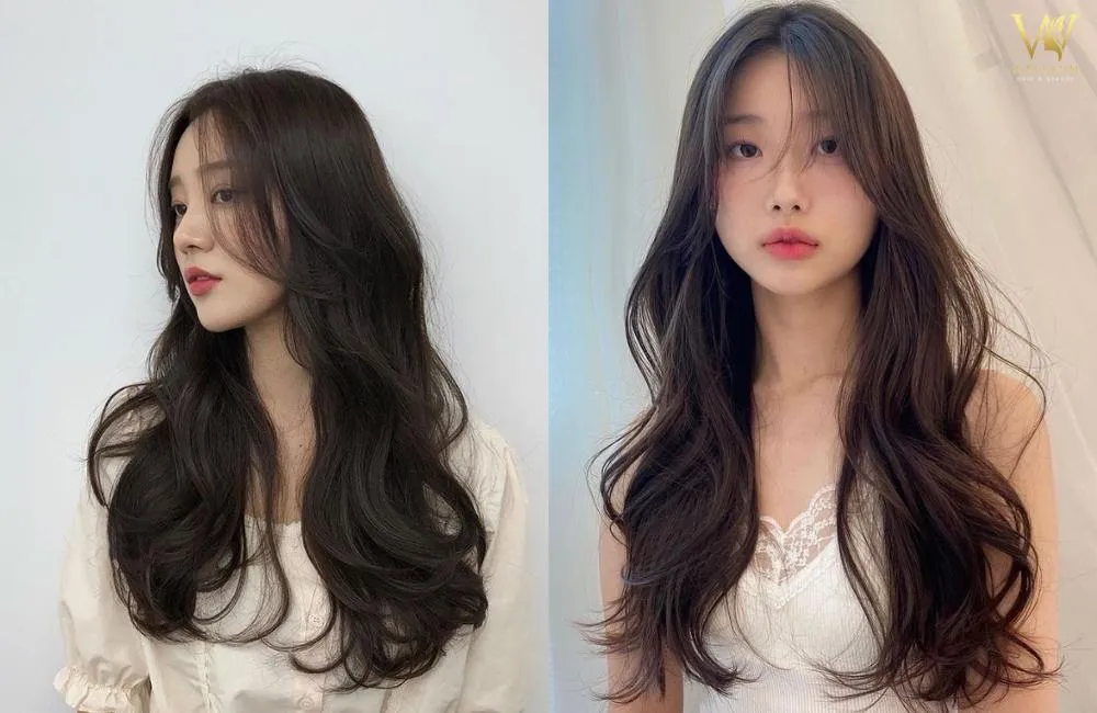 Tóc 2 mái uốn xoăn to kết hợp mái lưa thưa, tạo nên sự bồng bềnh và duyên dáng, làm nổi bật phong cách Hàn Quốc